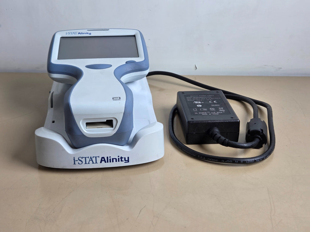 Abbott i-STAT Alinity analyzer seated in base station with power supply