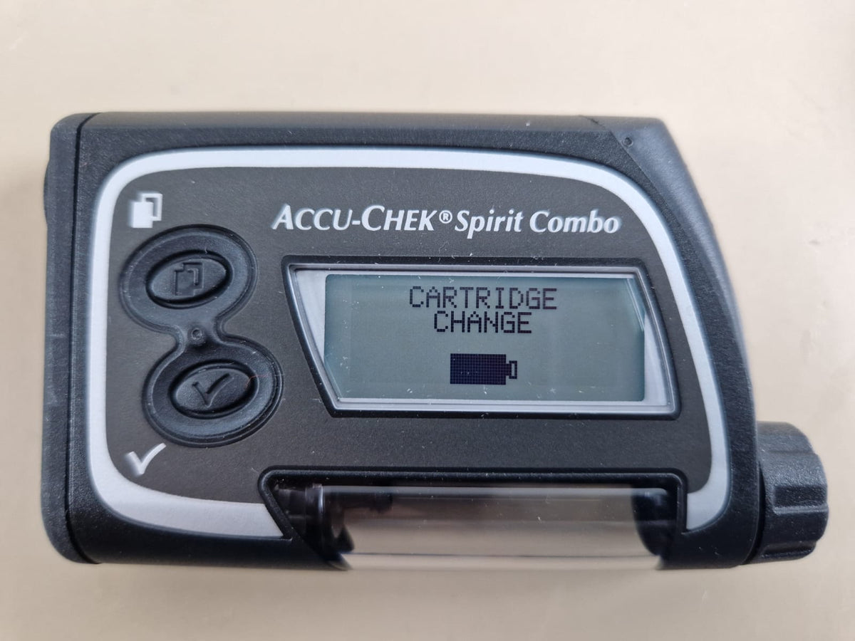 Accu-Chek Spirit Combo insulin pump front view showing cartridge change screen