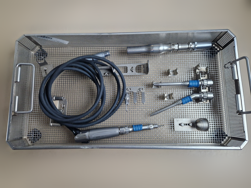 Aesculap Microspeed Uni neurosurgery drill set in basket — original photograph with cleaned tabletop background