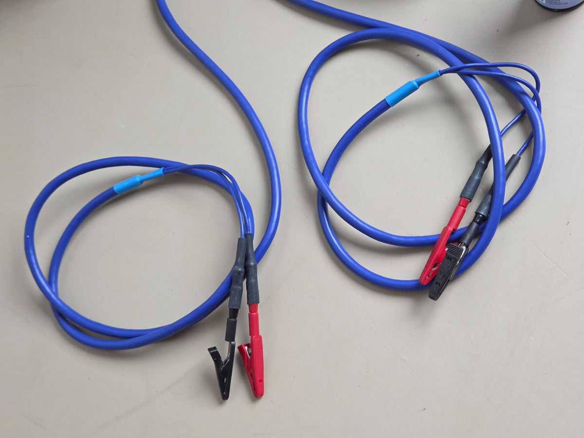 Two Bodystat QuadScan patient lead cable sets with red and black clips