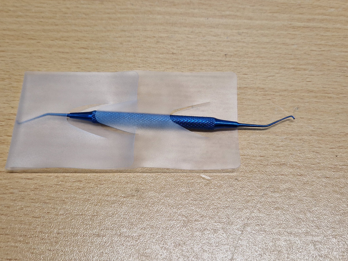 Full view of used blue double-ended Sinskey-type ophthalmic hook instrument