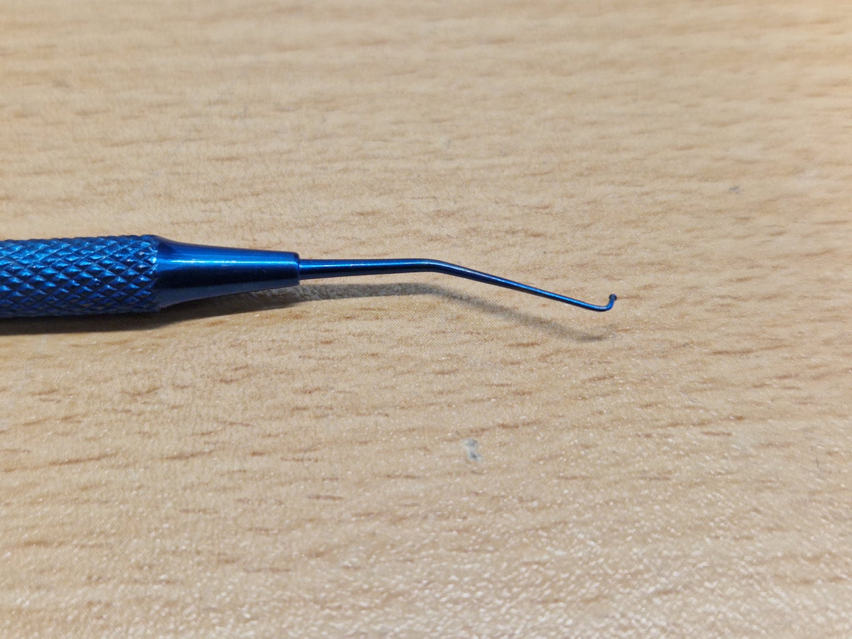 Close-up of fine hook tip on double-ended Sinskey-type ophthalmic instrument