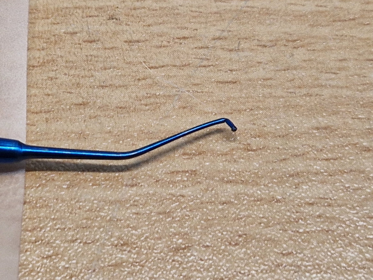 Close-up of reverse hook tip on double-ended Sinskey-type ophthalmic instrument
