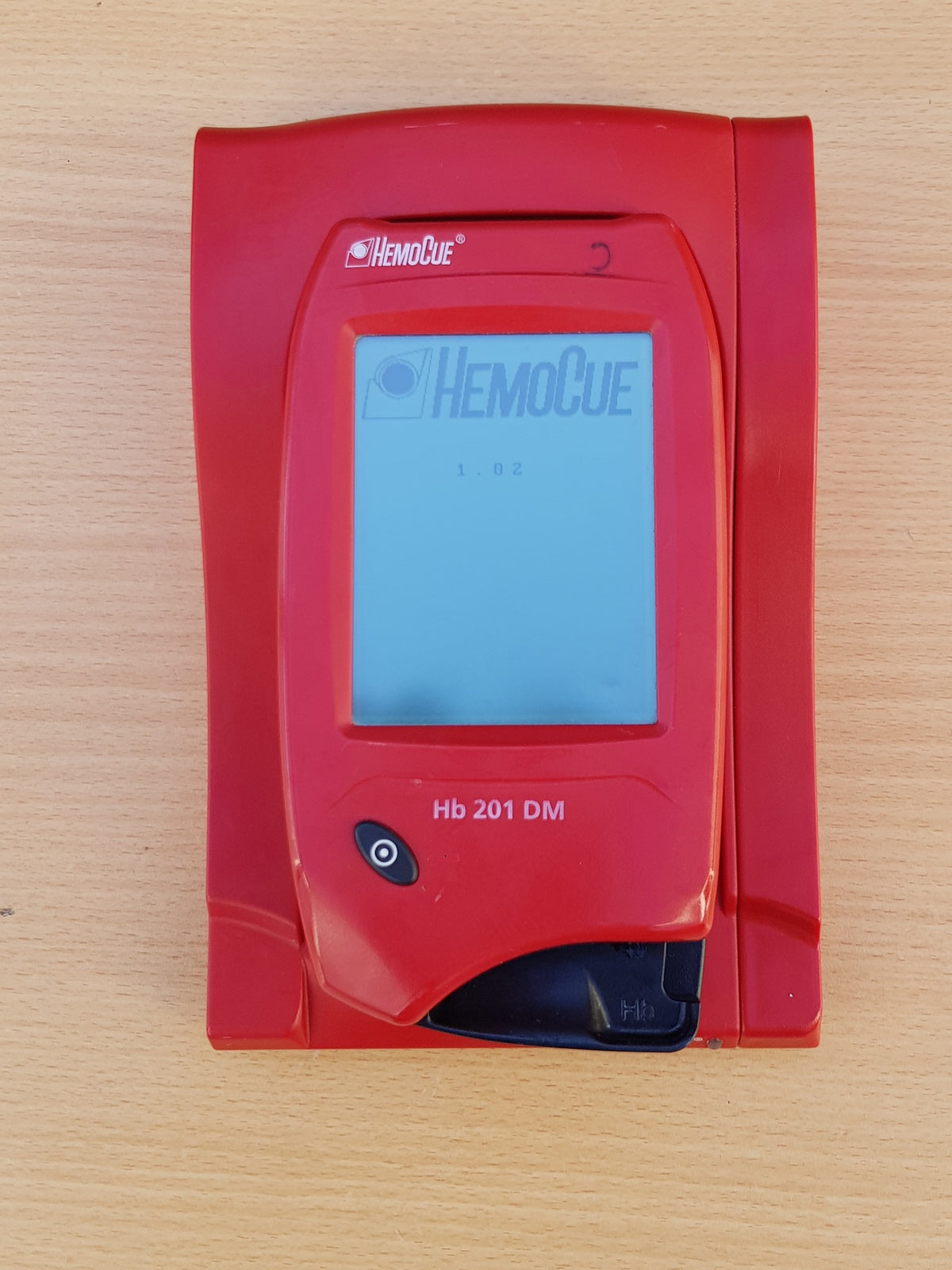 HemoCue Hb 201 DM hemoglobin analyzer with docking station front view