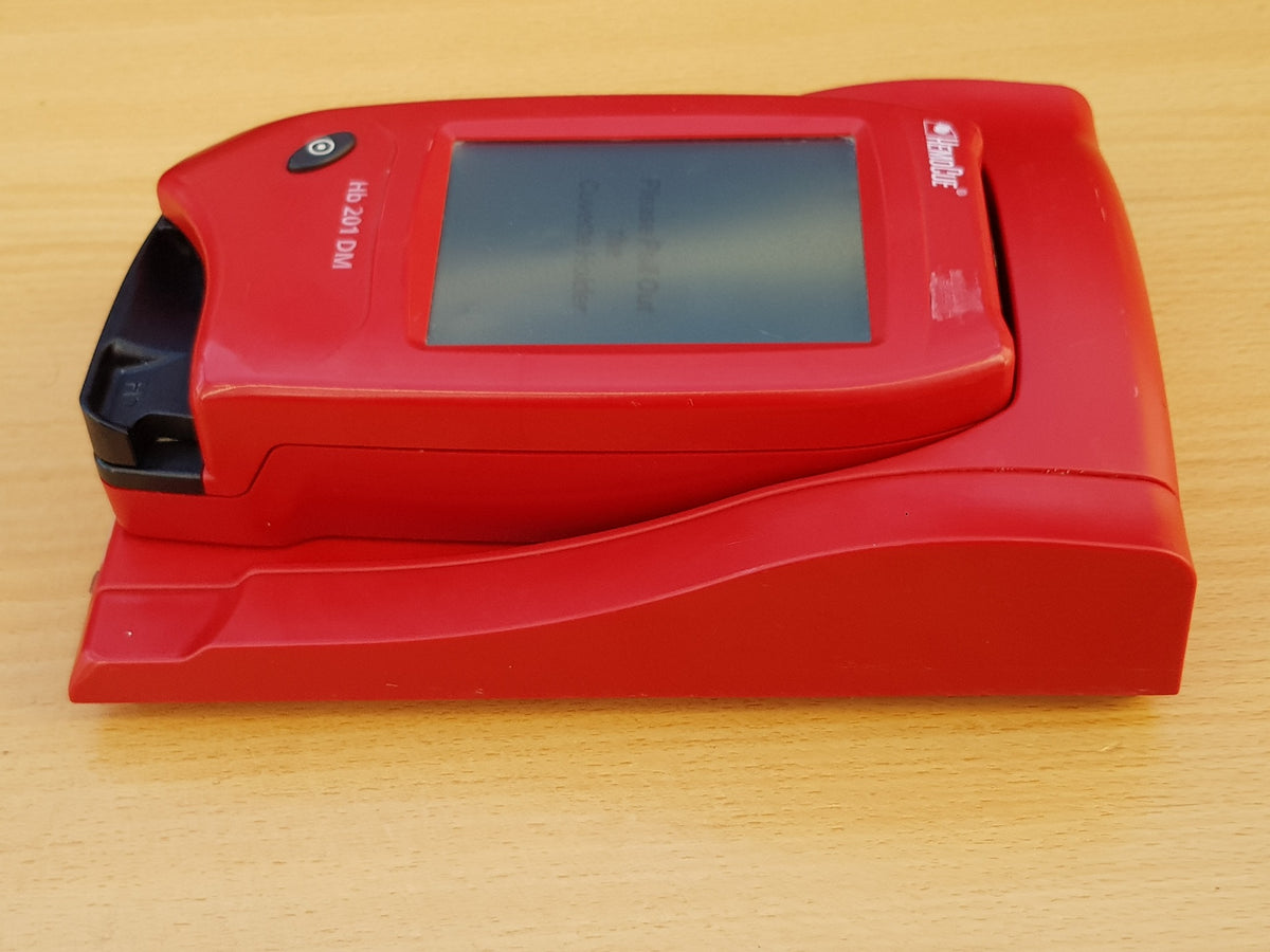 HemoCue Hb 201 DM analyzer docked on docking station side view