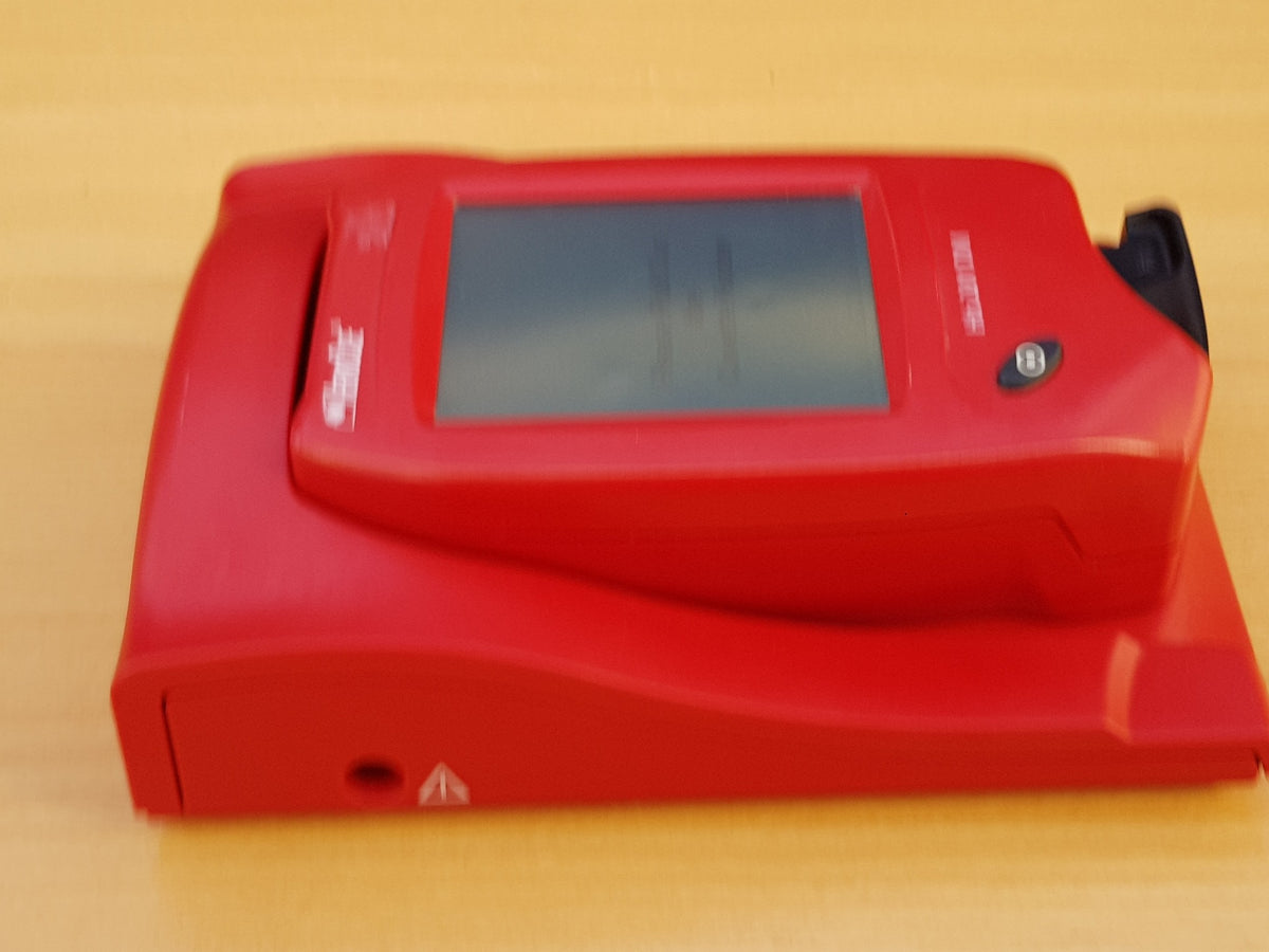 HemoCue Hb 201 DM hemoglobin analyzer and docking station angled view