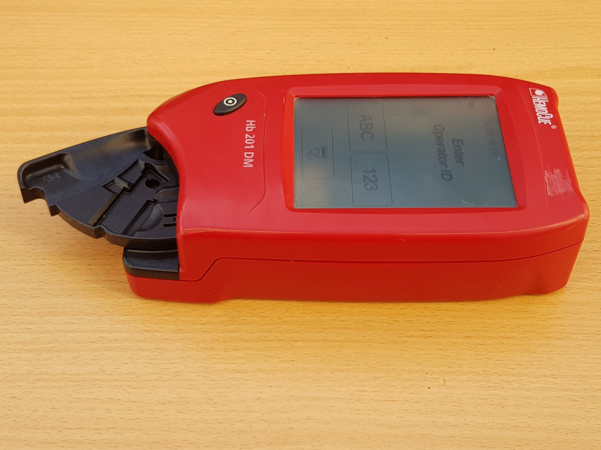 HemoCue Hb 201 DM analyzer powered on touchscreen