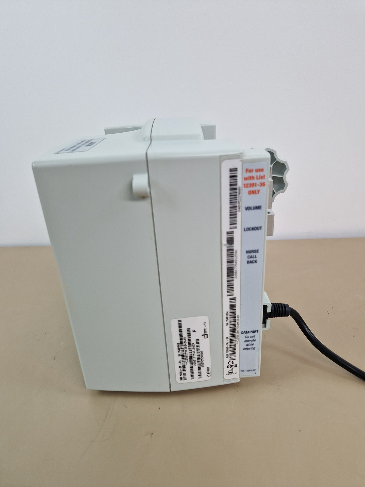 Hospira Plum A+ infusion pump side view showing dataport and volume controls
