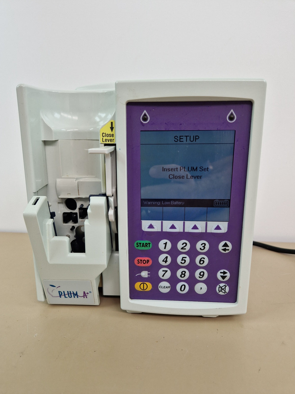 Hospira Plum A+ infusion pump powered display showing setup screen and low battery warning