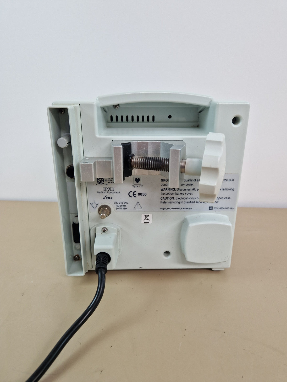 Hospira Plum A+ infusion pump rear view with pole clamp and power connection