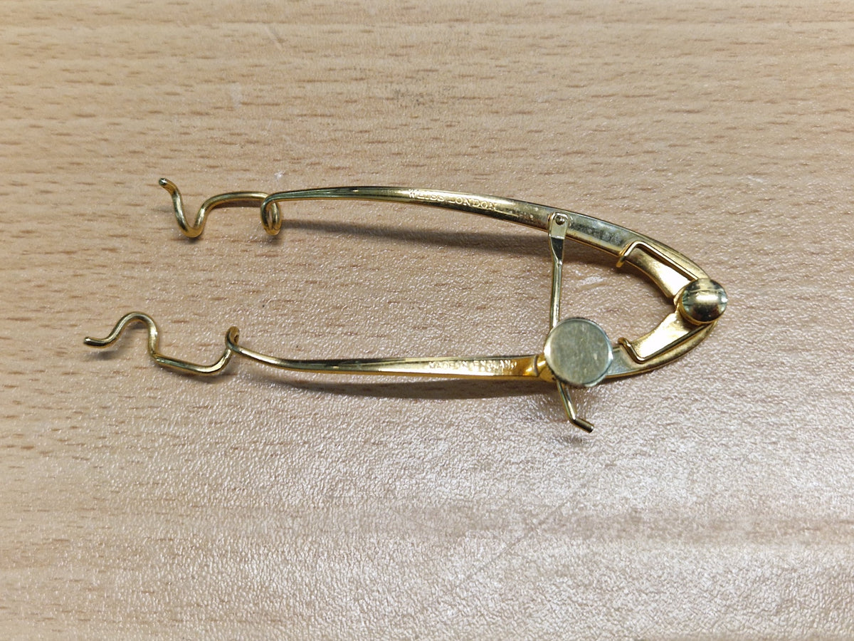 Keeler London ophthalmic adjustable eye speculum showing manufacturer marking and adjustment mechanism