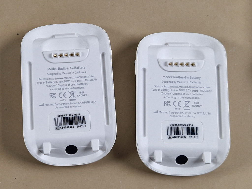 Masimo Radius-7 battery modules rear view showing 3.7V 1900mAh labels