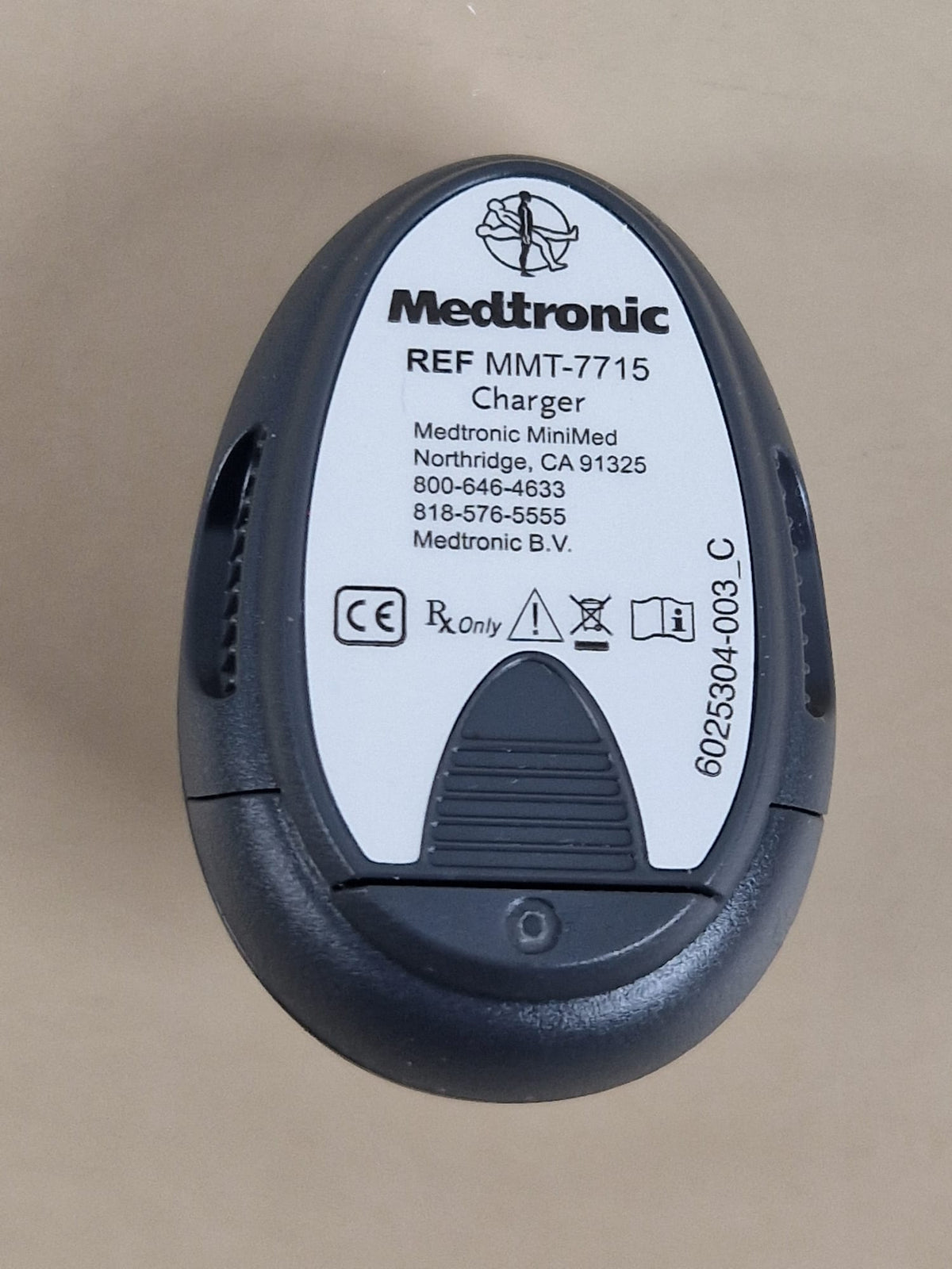 Medtronic MiniMed MMT-7715 used charger — manufacturer reference label