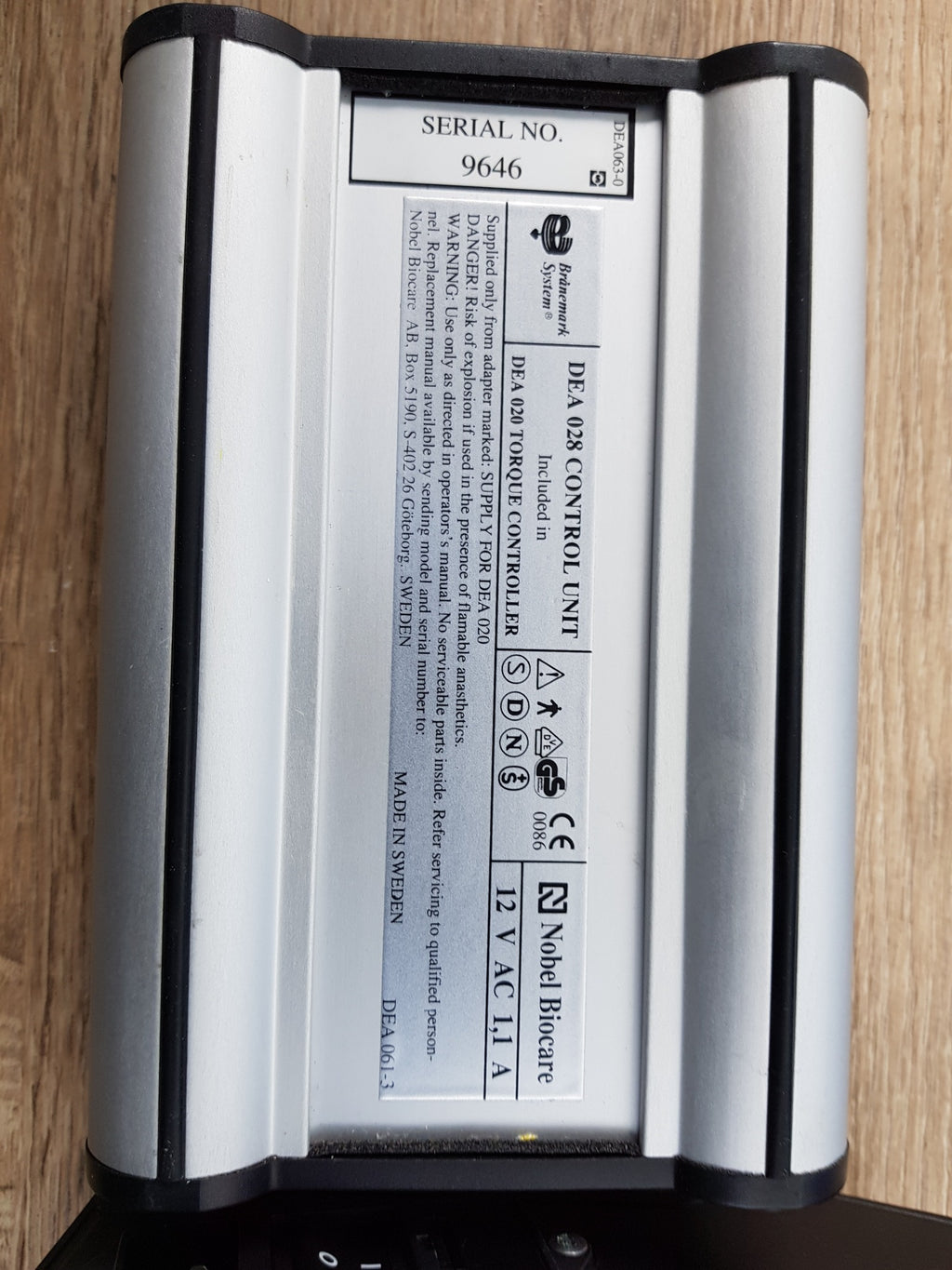 Close-up of Nobel Biocare DEA 028 control unit and DEA 020 torque controller label