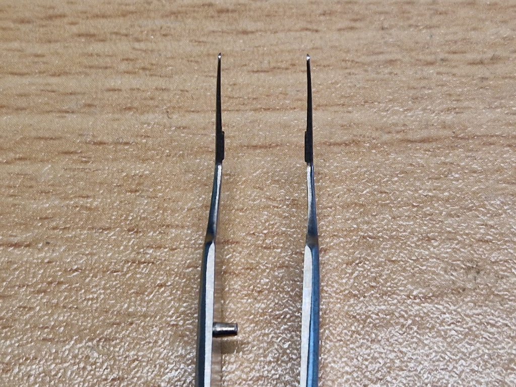 Close-up of fine angled ophthalmic tying forceps tips