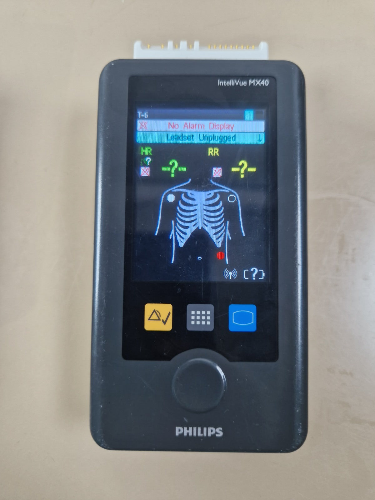 Philips IntelliVue MX40 wearable ECG telemetry monitor powered on; ECG cable and battery not included