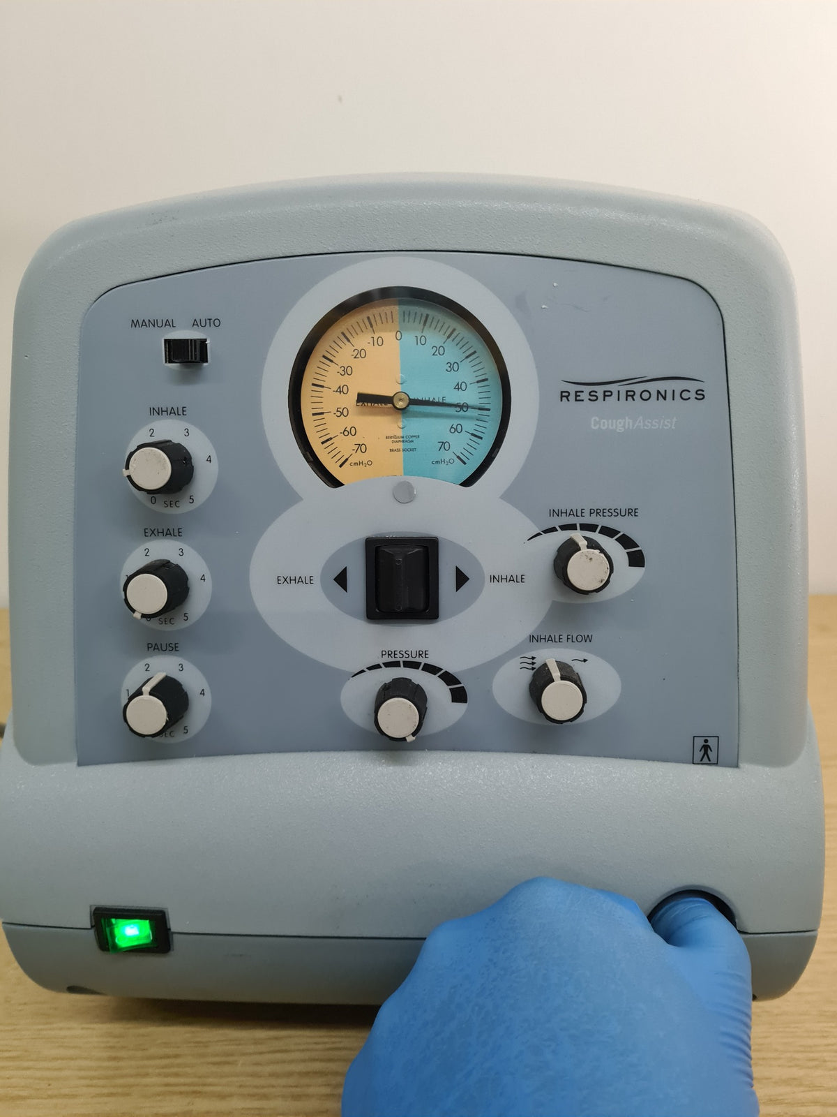 Respironics CoughAssist CA-3200 powered on showing pressure gauge