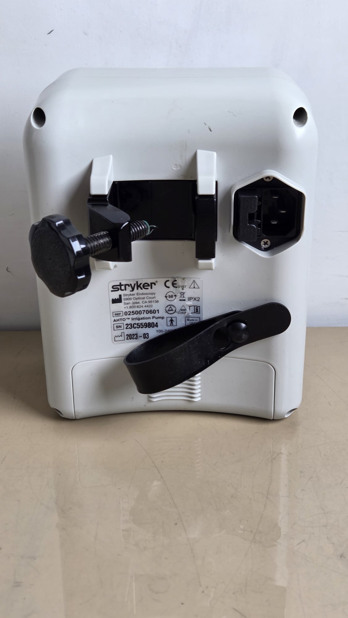 Stryker AHTO irrigation pump REF 0250070601 — rear label and clamp