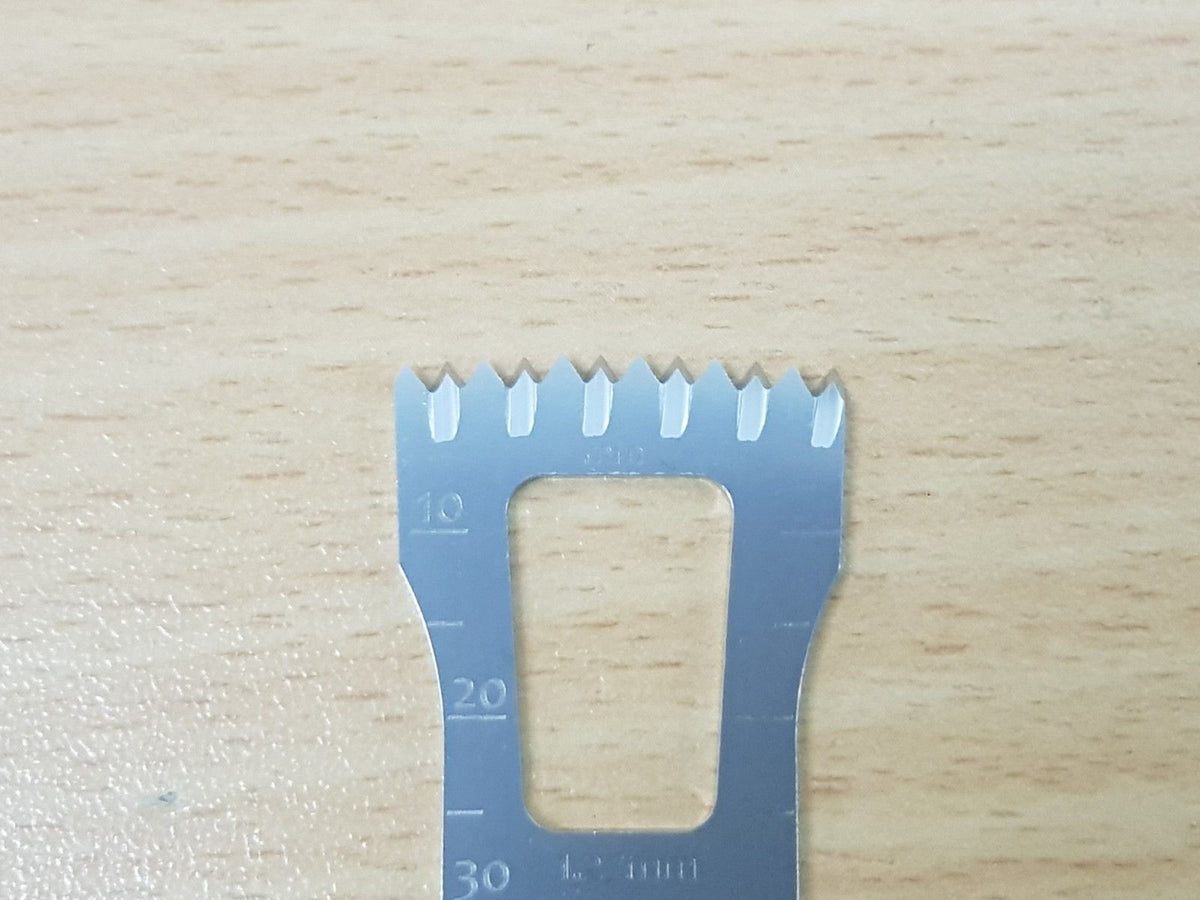 Close-up of Stryker surgical saw blade teeth and measurement markings