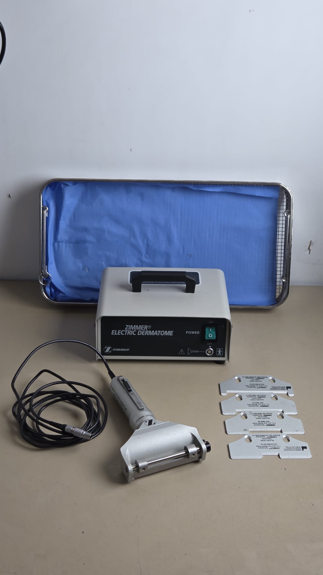 Zimmer electric dermatome set with handpiece, power console, four width plates and metal instrument tray