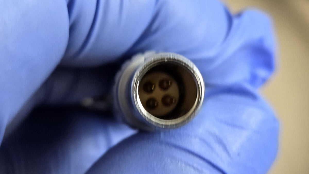 Close-up of the four-contact metal connector on the Zimmer electric dermatome handpiece cable