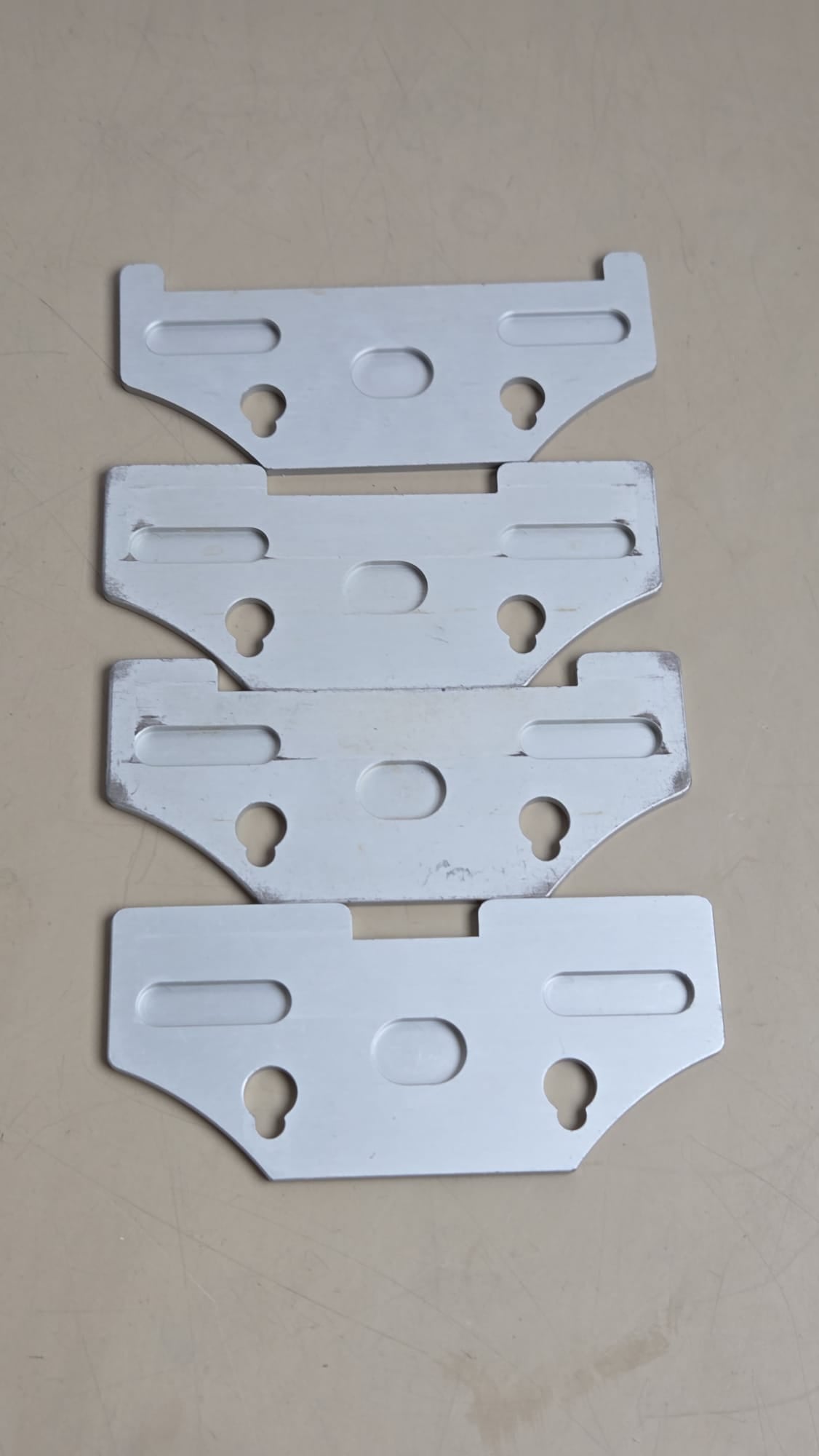 Reverse sides of four used Zimmer dermatome width plates