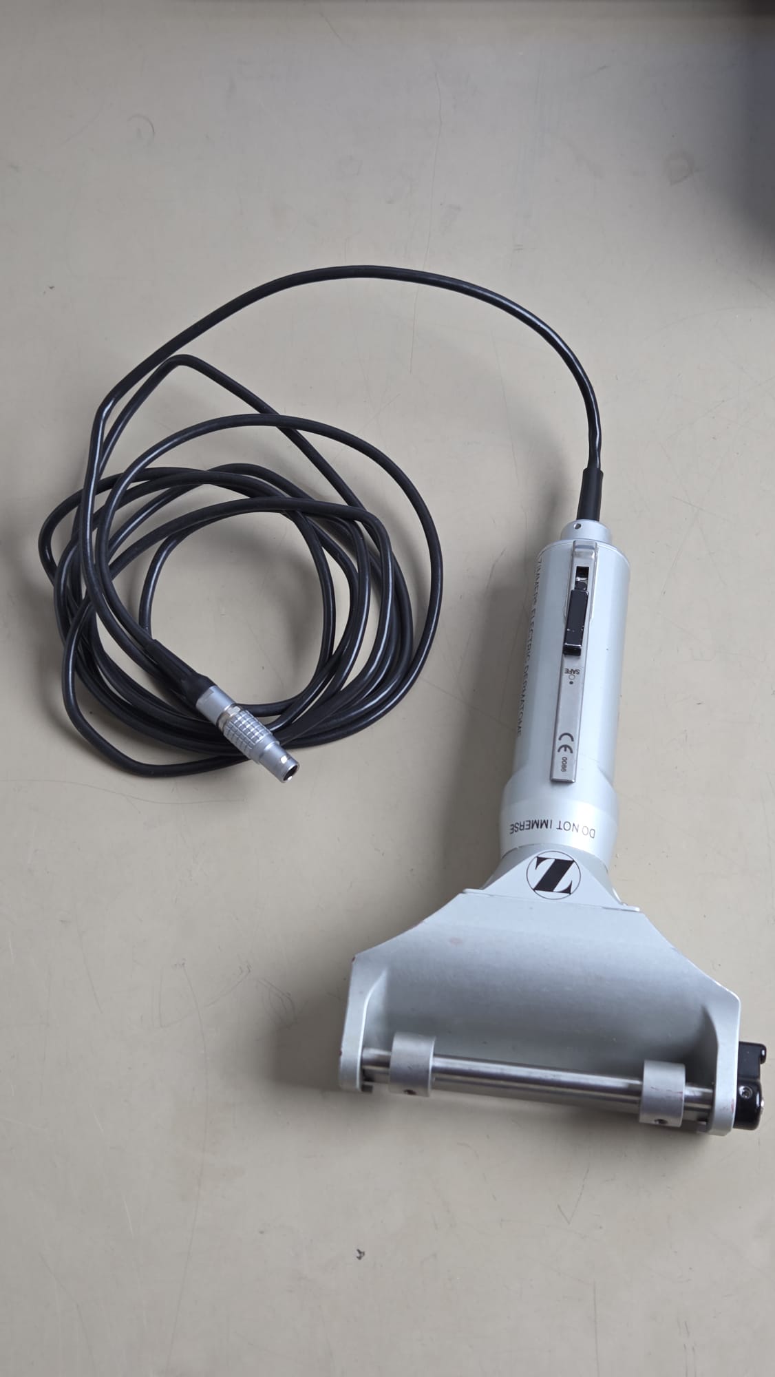 Zimmer electric dermatome handpiece with attached black cable and metal connector